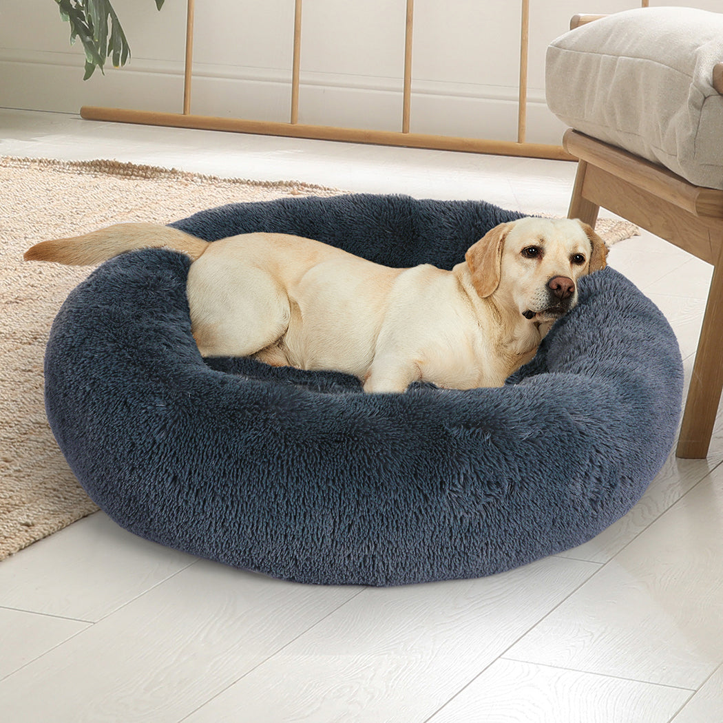 Dog curled up and relaxing on the PaWz ZenNest Donut aniti anxiety bed